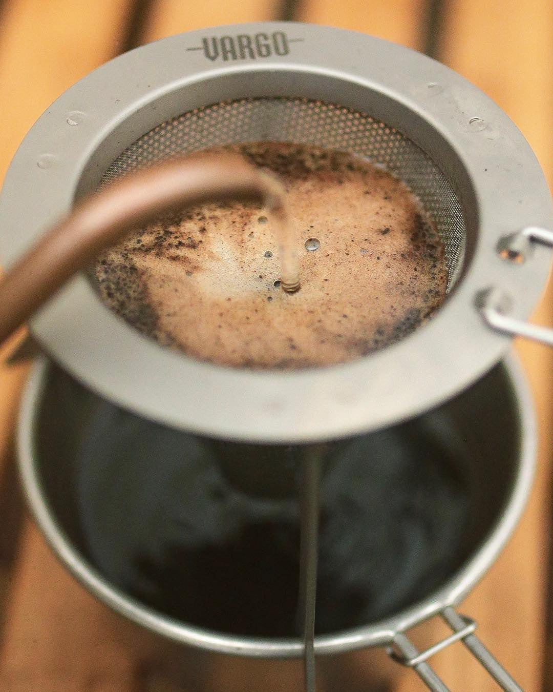 Pouring coffee on the Titanium Travel Coffee Filter